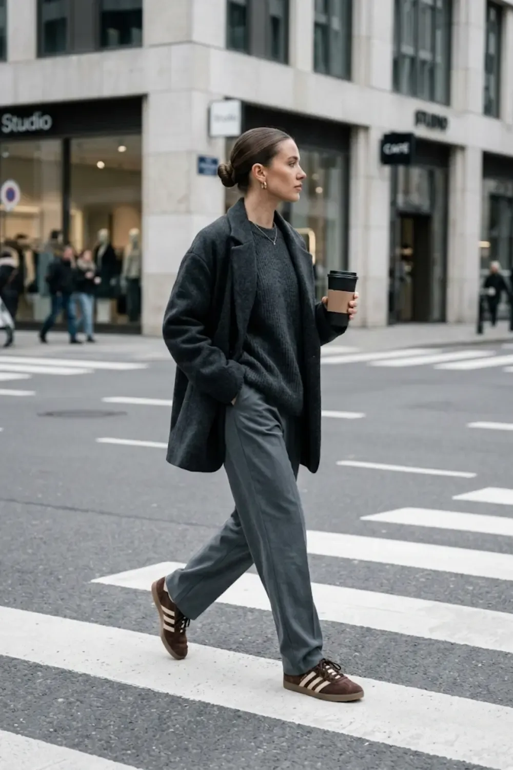 A style-conscious woman embodying the 'Boring Shoe' aesthetic with high-fashion execution, captured in a full-body street style shot.