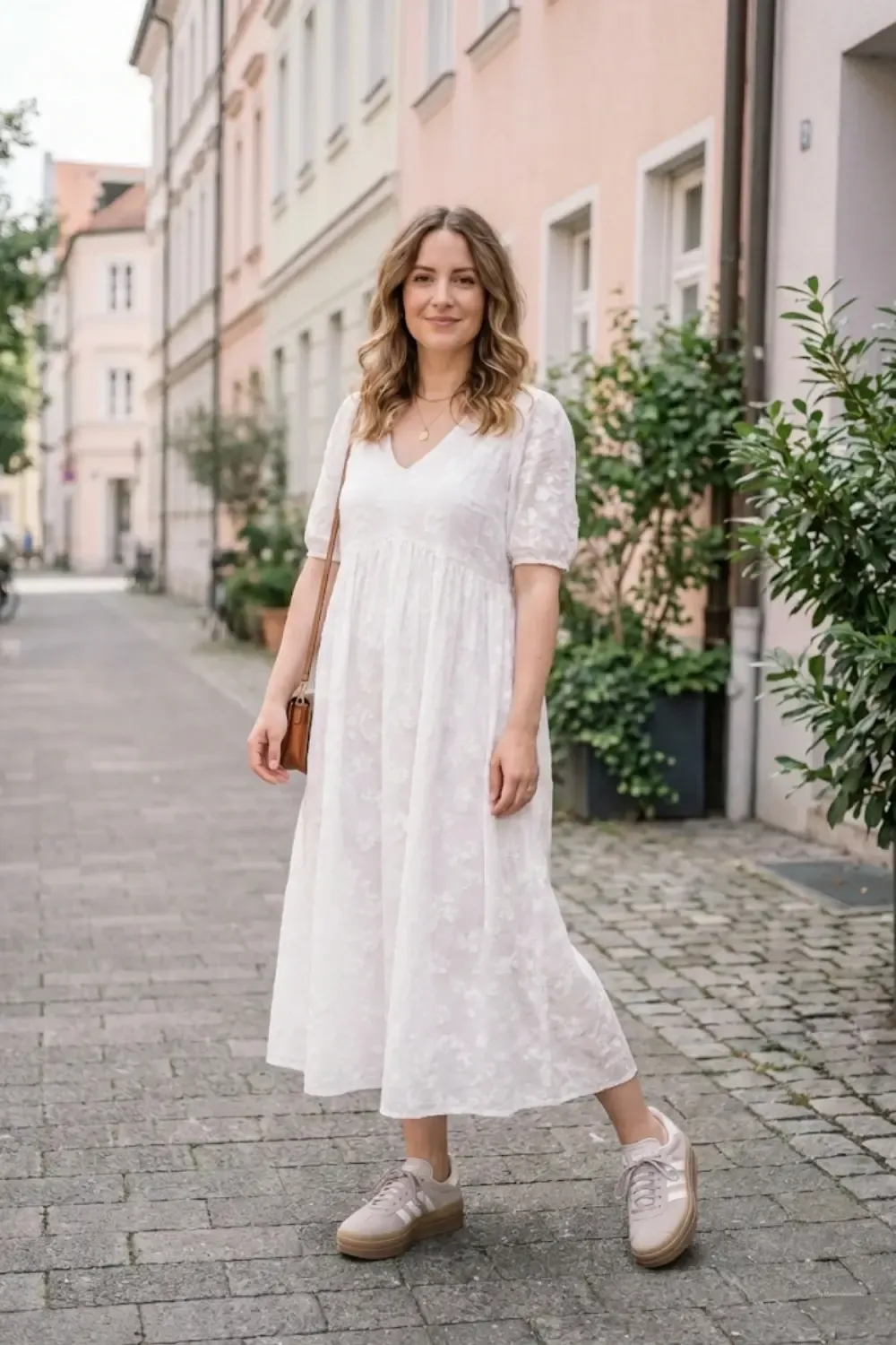 Woman in white midi dress with Adidas Gazelle Bold