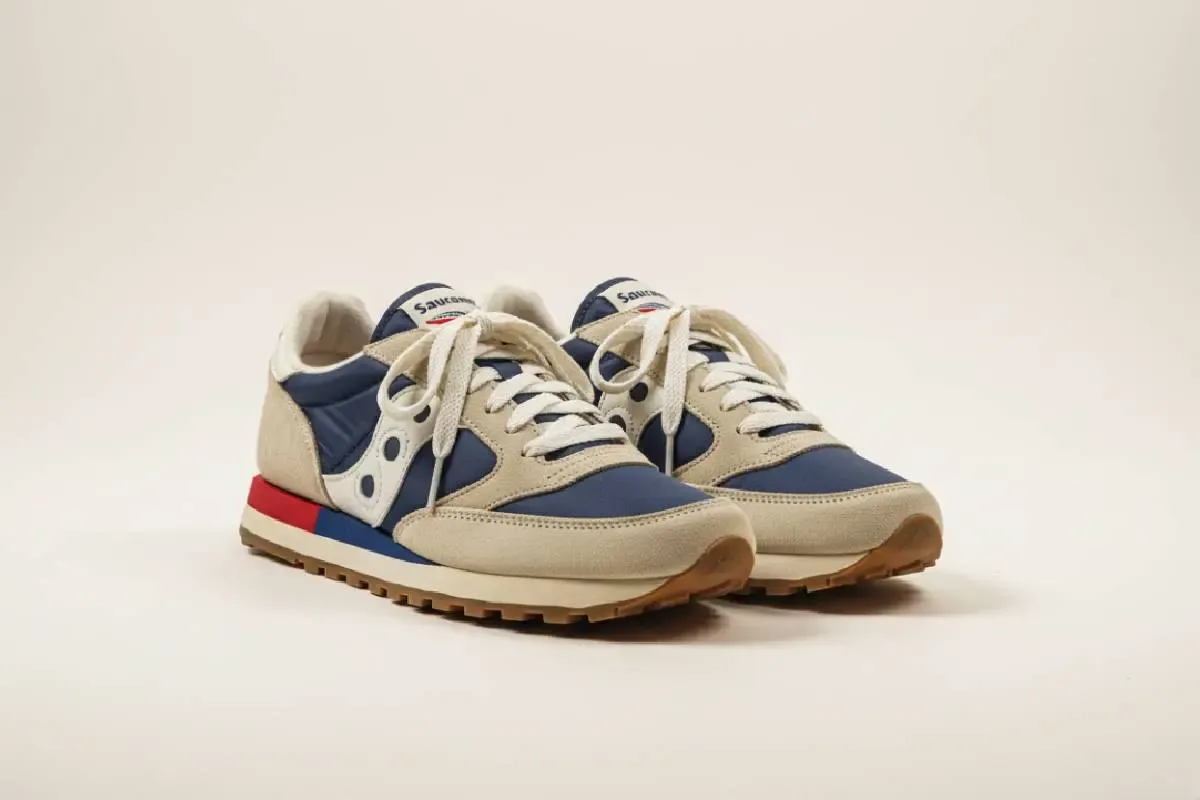 A pair of retro 1981 Saucony Jazz trainers, showing their classic blue suede and nylon design.