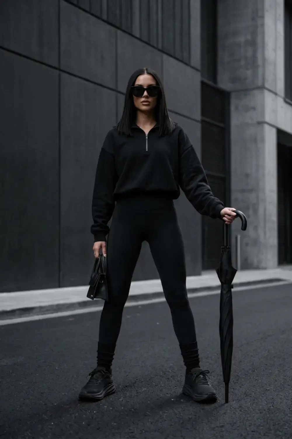 An 'Edgy Urban' woman showcasing a sophisticated all-black ensemble.
