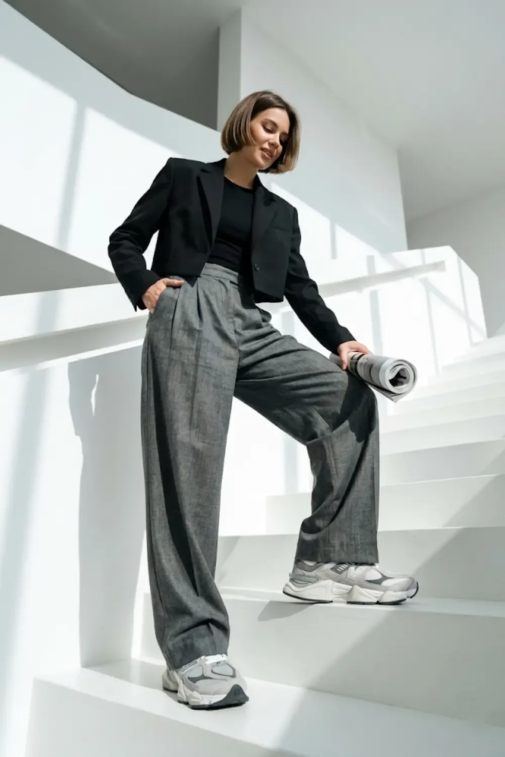 A fashion editor demonstrating the 'High-Low Harmony' of proportions with New Balance 9060